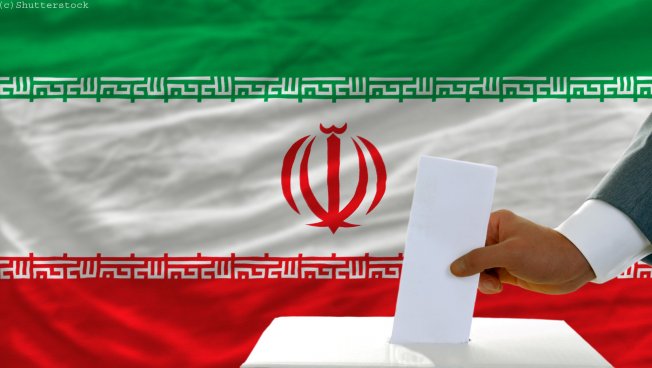 Wahlurne vor iranischer Flagge