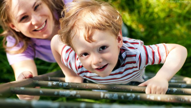 Mutter spielt mit Kind im Grünen